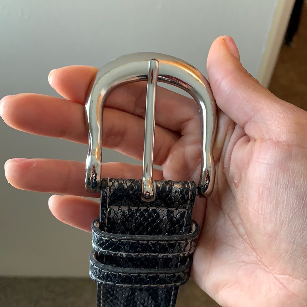 Used black and silver snake print belt.